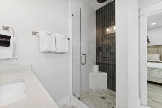 bathroom featuring a shower with shower door and hardwood / wood-style flooring