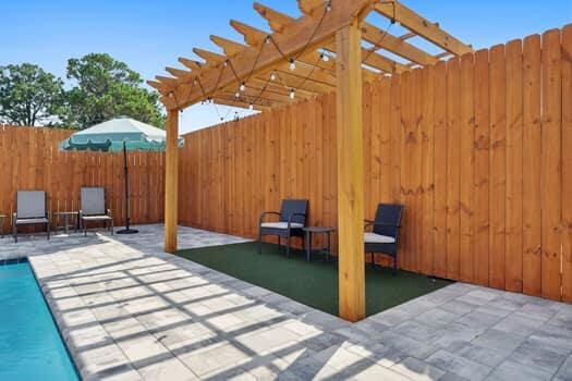 view of patio / terrace featuring a fenced in pool and a pergola