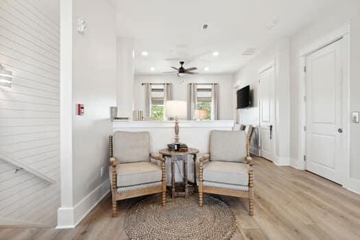 sitting room featuring ceiling fan and hardwood / wood-style flooring