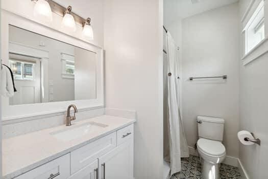 bathroom with large vanity, toilet, and tile flooring