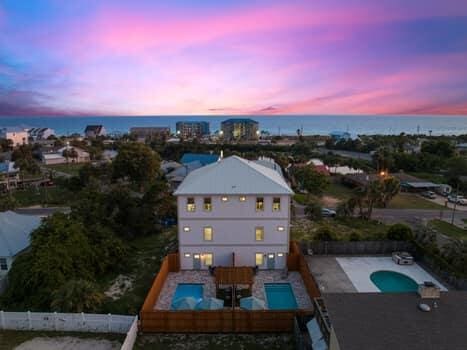 aerial view at dusk featuring a water view