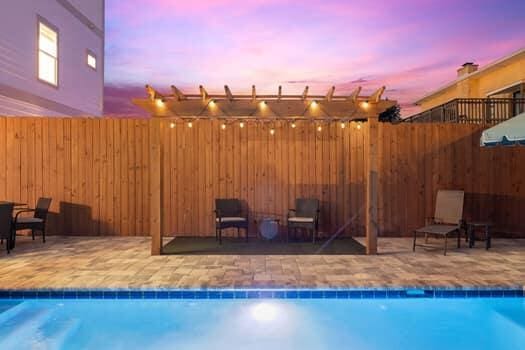 pool at dusk featuring a patio area