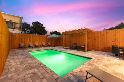 pool at dusk featuring a patio area