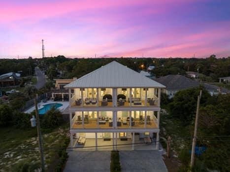 back house at dusk featuring a patio