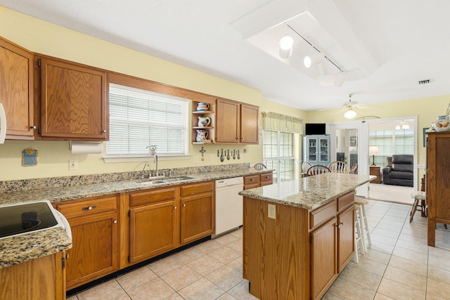 kitchen featuring a center island, plenty of natural light, dishwasher, and track lighting