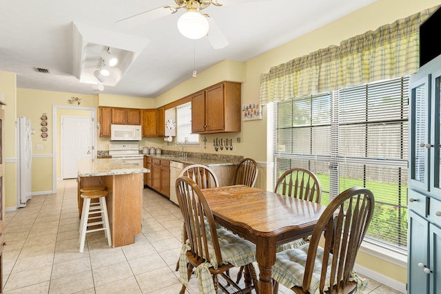 tiled dining area featuring sink and ceiling fan