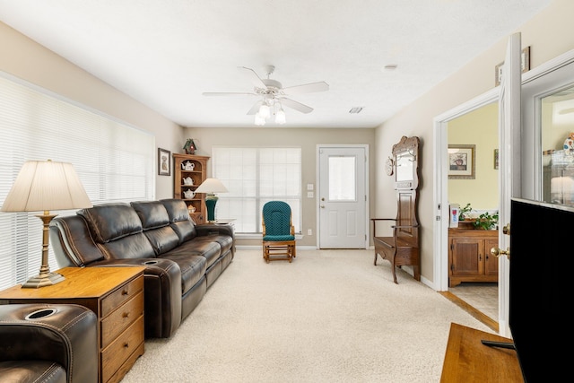 living room featuring light colored carpet and ceiling fan