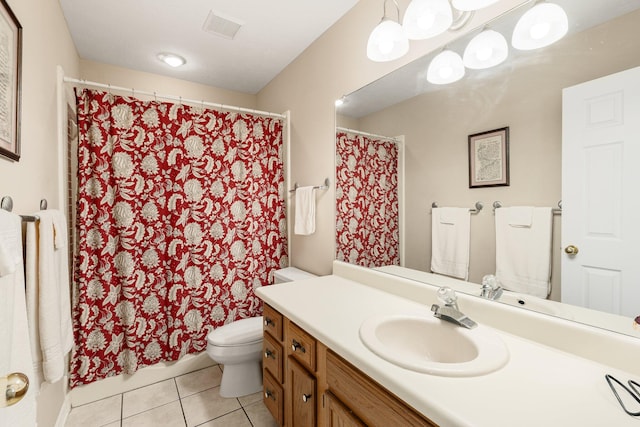 bathroom with toilet, vanity with extensive cabinet space, and tile flooring