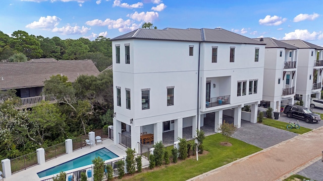 view of building exterior with a fenced in pool