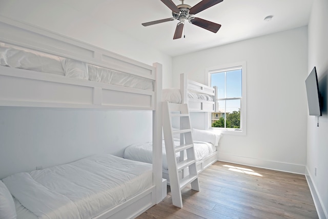 bedroom with ceiling fan and hardwood / wood-style flooring