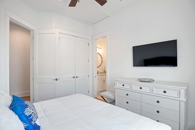 bedroom with hardwood / wood-style floors, ensuite bath, ceiling fan, and a closet