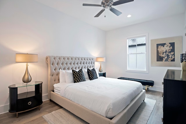 bedroom with ceiling fan and hardwood / wood-style flooring