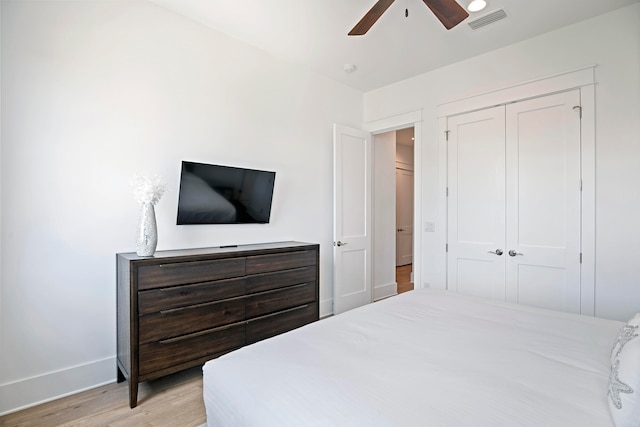 bedroom featuring a closet, ceiling fan, and light hardwood / wood-style floors