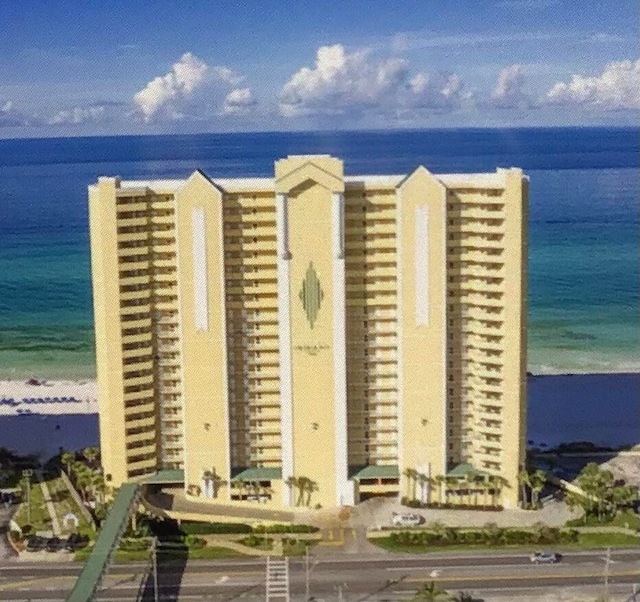 view of property featuring a view of the beach and a water view