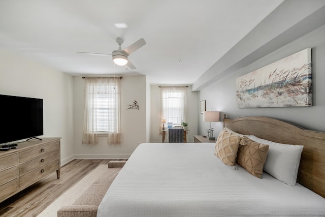 bedroom featuring ceiling fan, wood finished floors, and baseboards