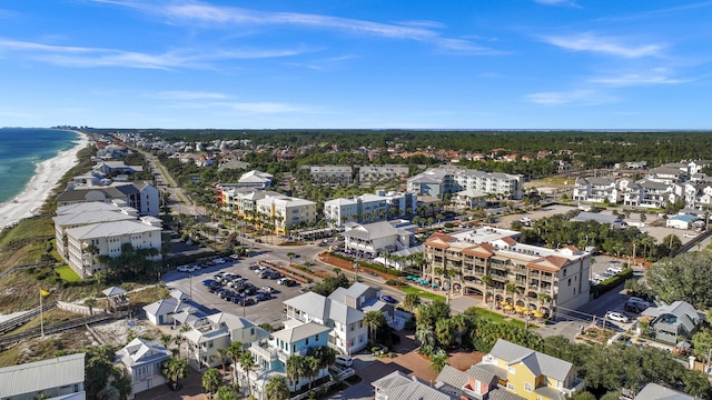 birds eye view of property with a water view and a beach view