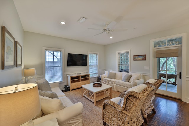 living room featuring wood-type flooring and ceiling fan