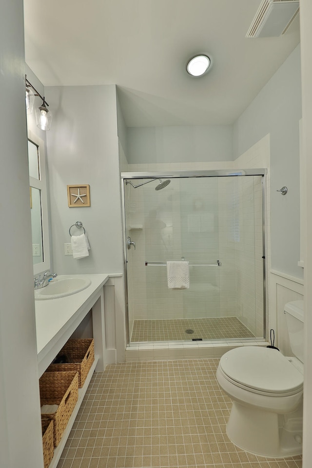 bathroom with tile floors, an enclosed shower, vanity, and toilet