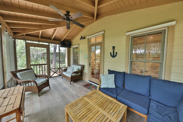 sunroom featuring ceiling fan, lofted ceiling with beams, and wooden ceiling