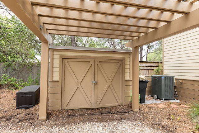 view of outdoor structure with a pergola and central air condition unit