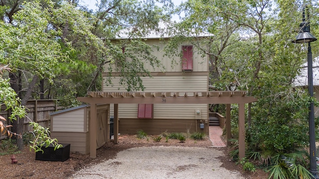 rear view of house featuring a pergola