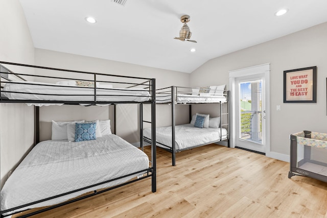 bedroom featuring light hardwood / wood-style floors and lofted ceiling