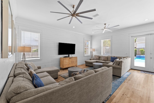 living room with ceiling fan and light hardwood / wood-style floors