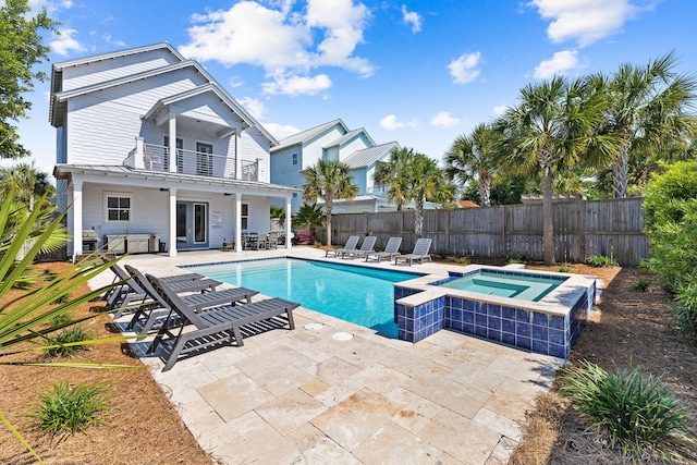 view of pool with an in ground hot tub and a patio