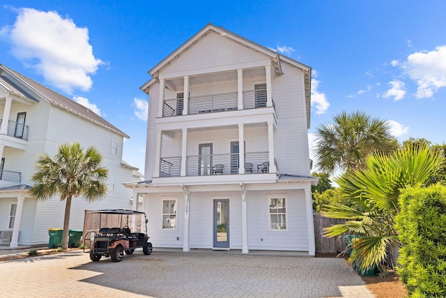 view of front facade with a carport and a balcony