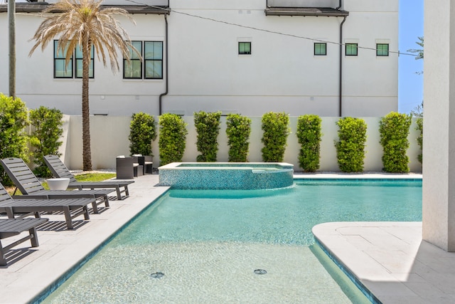 view of pool with a patio and an in ground hot tub