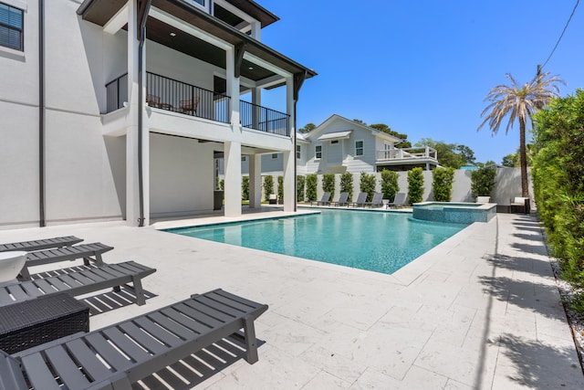 view of swimming pool with an in ground hot tub and a patio area