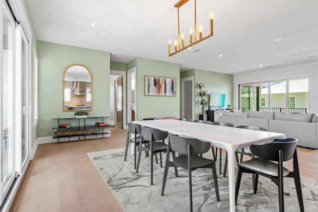 dining room with an inviting chandelier and light wood-type flooring