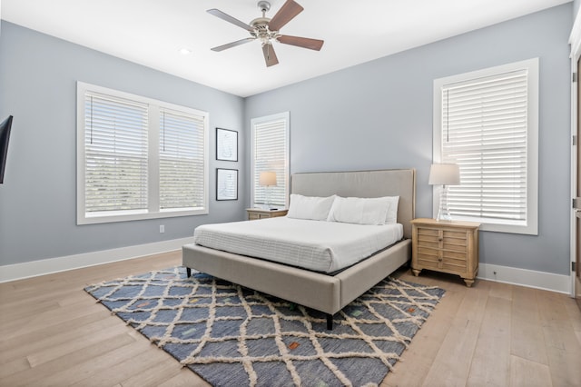 bedroom with ceiling fan and light hardwood / wood-style floors