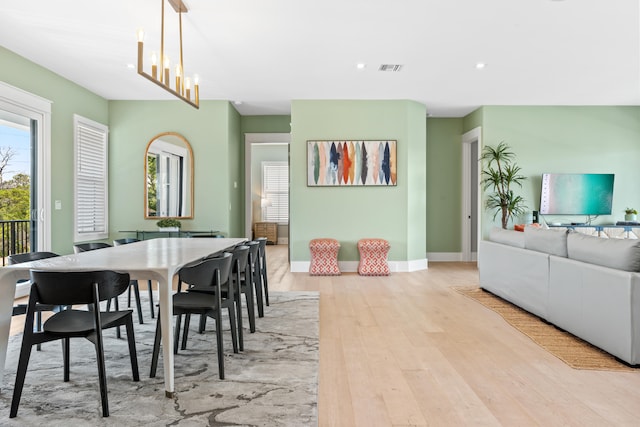 dining room featuring a chandelier and light hardwood / wood-style flooring