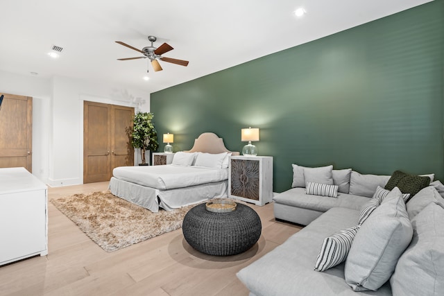 bedroom with ceiling fan and light hardwood / wood-style flooring