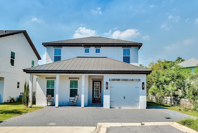 view of front of property with a garage and covered porch