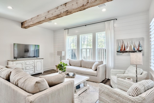 living room featuring dark hardwood / wood-style floors and beam ceiling