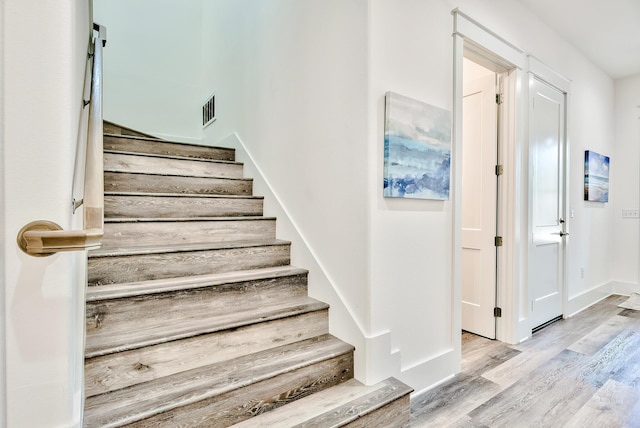 stairway featuring light wood-type flooring