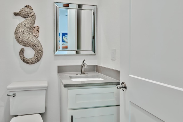 bathroom featuring vanity and toilet