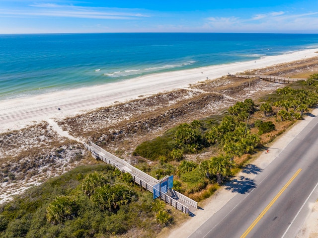 drone / aerial view with a beach view and a water view