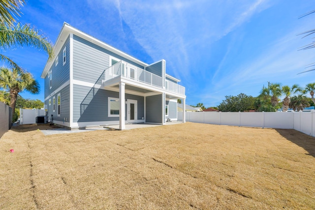 back of house featuring a patio area, central AC unit, and a lawn