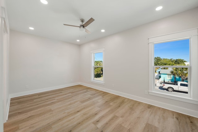 empty room with ceiling fan and light wood-type flooring