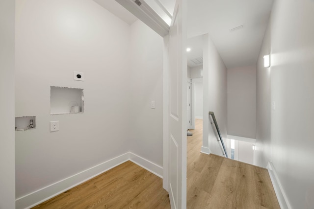 hallway with light hardwood / wood-style floors