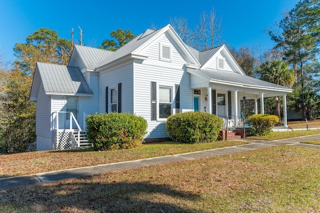 view of front of home with a porch and a front yard