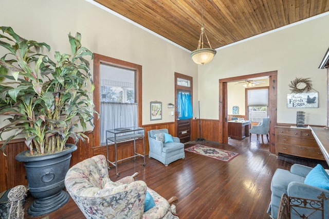 living area with ceiling fan, dark hardwood / wood-style flooring, wood ceiling, and crown molding