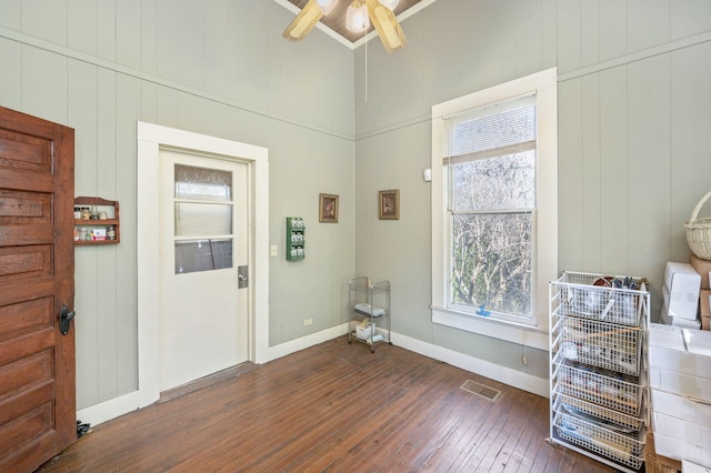 entrance foyer featuring dark hardwood / wood-style flooring, ceiling fan, and ornamental molding