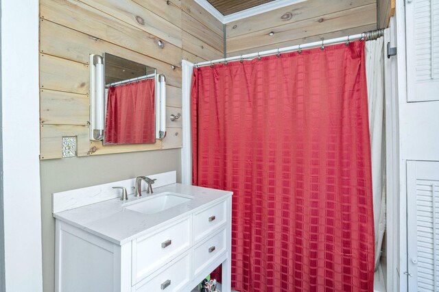 bathroom featuring vanity and wood walls