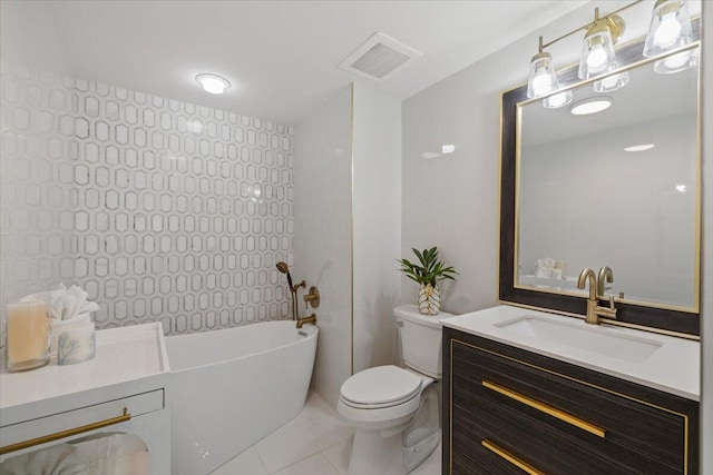 bathroom with tile patterned floors, toilet, a bathtub, vanity, and tile walls