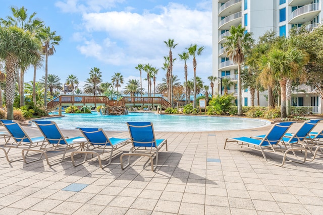 view of swimming pool with pool water feature