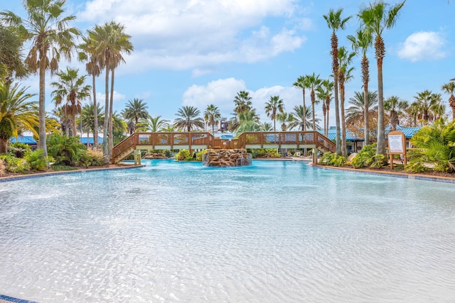 view of swimming pool with pool water feature